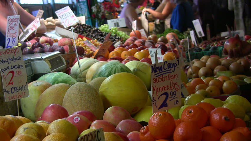 Girl picking out fresh produce at a market. HD 1080i