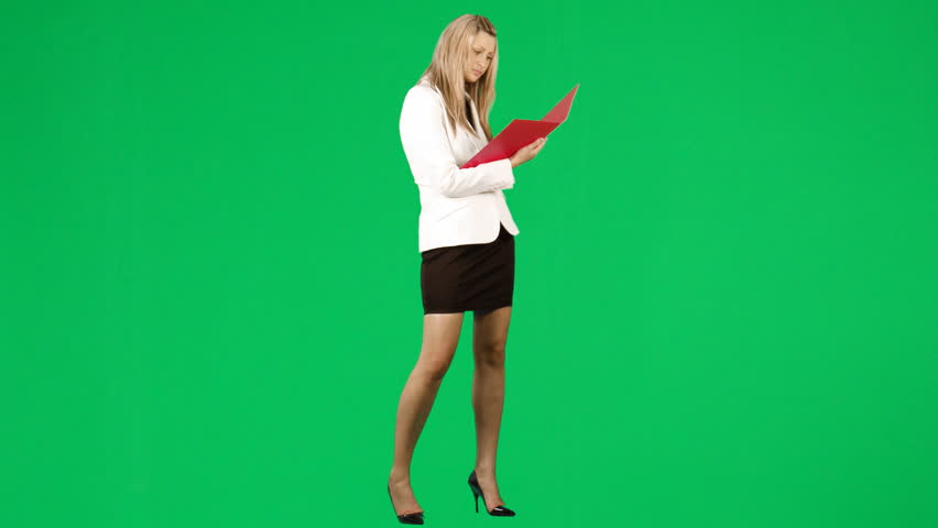  	Businesswoman reading a report against green screen footage