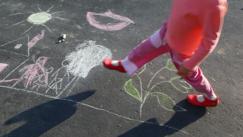 little girl walking on drawing on asphalt 