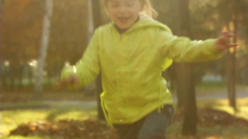 Sequence of slow motion shots happy mum and the little girl throw autumn leaves.