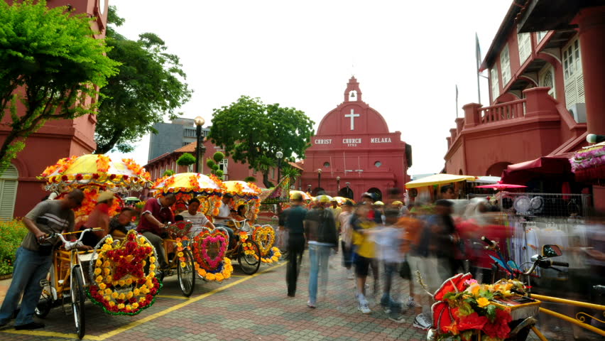 MALACCA - SEPTEMBER 22: Tourist activity in front Christ Church Malacca September 22, 2009 in Malacca State, Malaysia.
