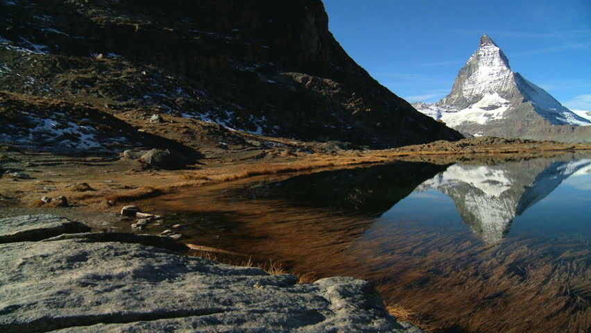 Matterhorn reflected in clear alpine lake, Switzerland