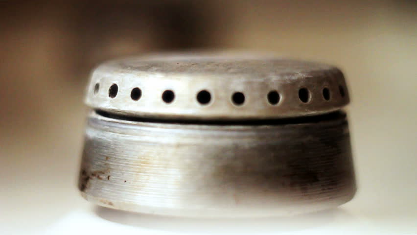 Two gas ring burners on a home cooker, shallow depth of field