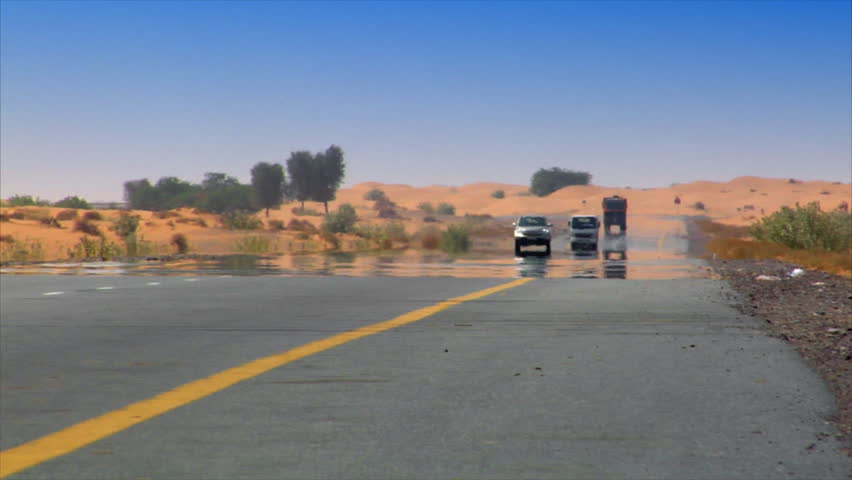 DUBAI - SEPTEMBER 9: A long distance shot with cars coming out of the waving heat / haze of the desert., somwhere on the streets of Dubai on September 9.2009, Dubai, UAE. No logo or signs visible.