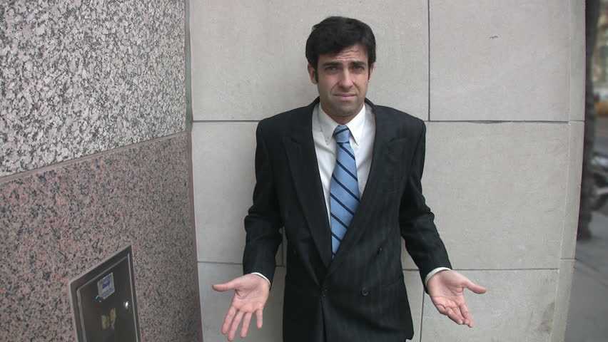 Puzzled guy.A young businessman shrugs his shoulders.