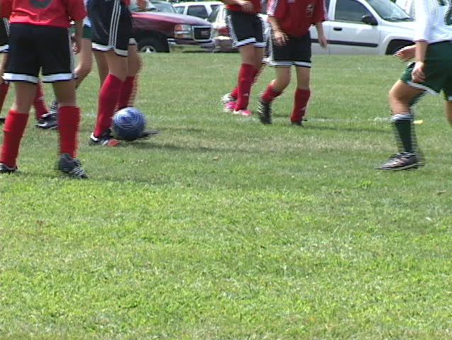 girls' soccer team kicking the ball