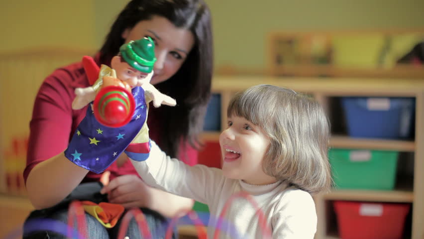 Sequence of female teacher and little girl playing in kindergarten (multiple shots)