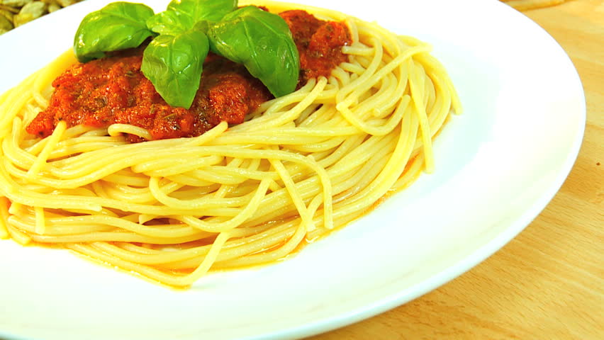 Traditional italian spaghetti bolognese dressed with fresh basil leaves ready to eat