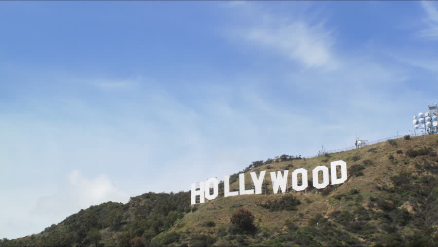 LOS ANGELES - APRIL 4: Famous Hollywood Sign letters on top of hill with clouds moving over blue sky in the background. HD Time lapse. April 4, 2010 in Los Angeles, California.