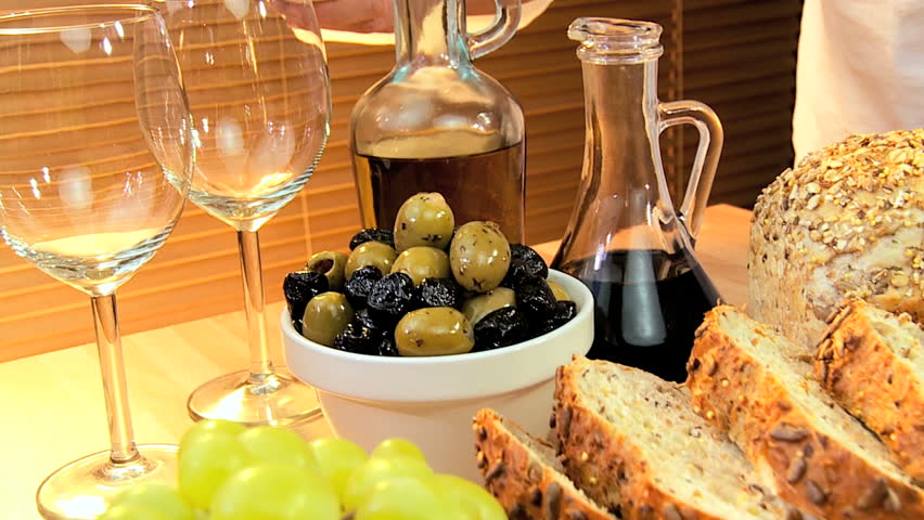 Healthy selection of cheeses, whole-grain bread,oils & fruit served with white wine for a modern lifestyle lunch