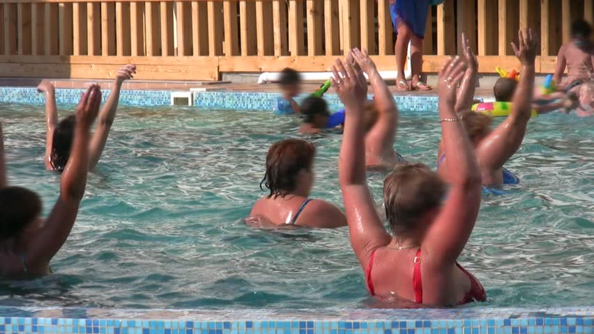 people doing aqua aerobic in swimming pool outdoor 