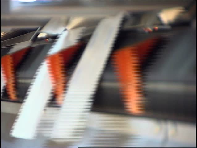 Close-up of the conveying process of a full-automatic stitching unit (DVCPRO Quality in PAL format - artifacts are only in web-preview)