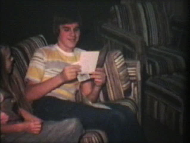 A teenage boy celebrating his thirteenth birthday opens up some groovy presents with help from his younger sisters.