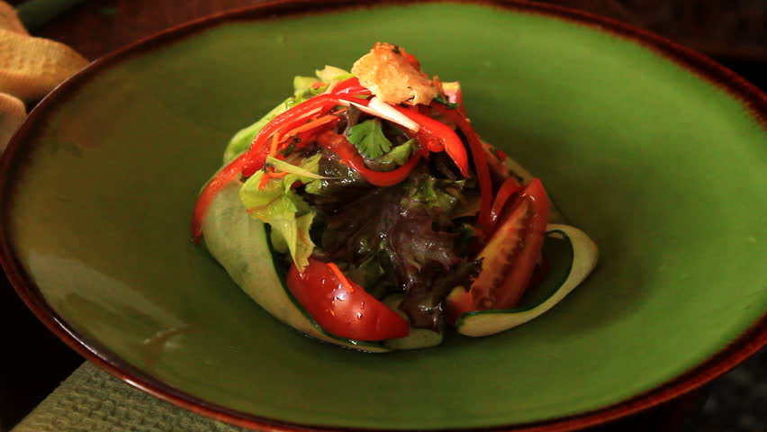 A chef preparing chicken salad for serving 