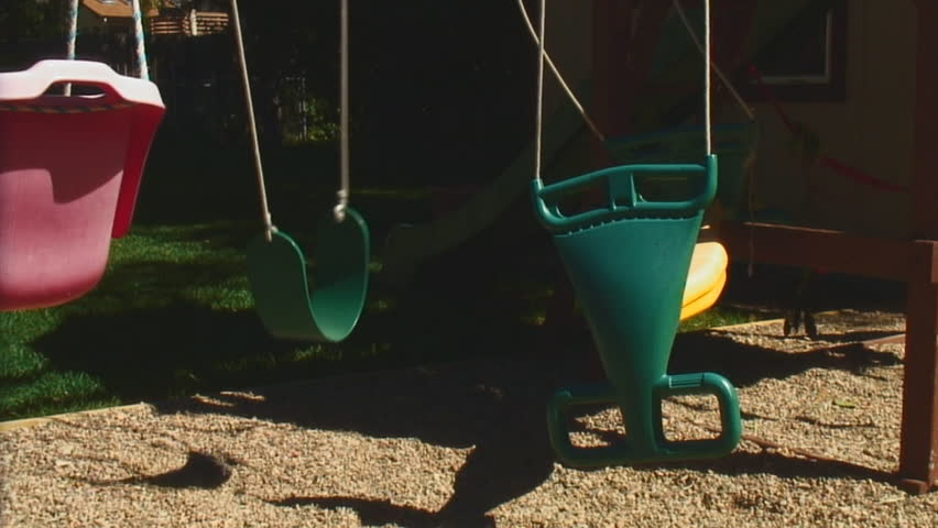 Empty swings in a backyard playground - HD