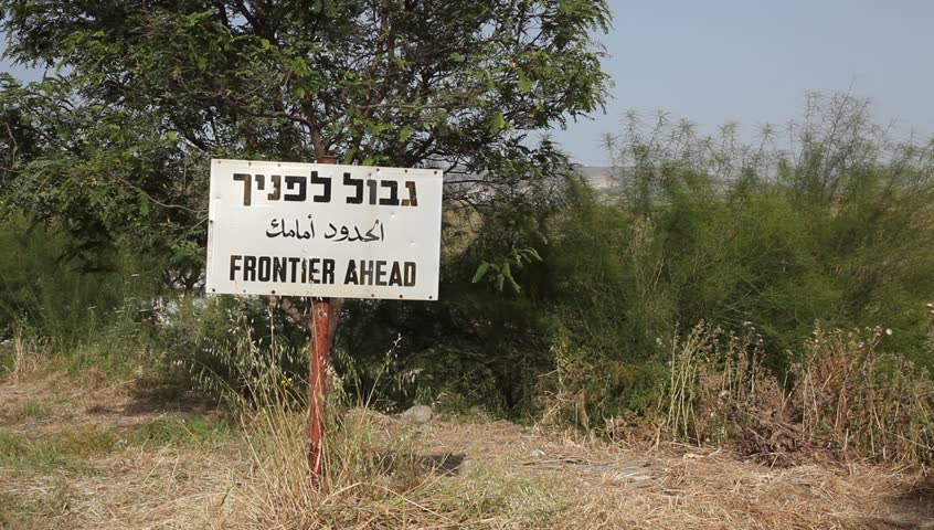 Frontier ahead sign in three languages on the border between Israel and Jordan