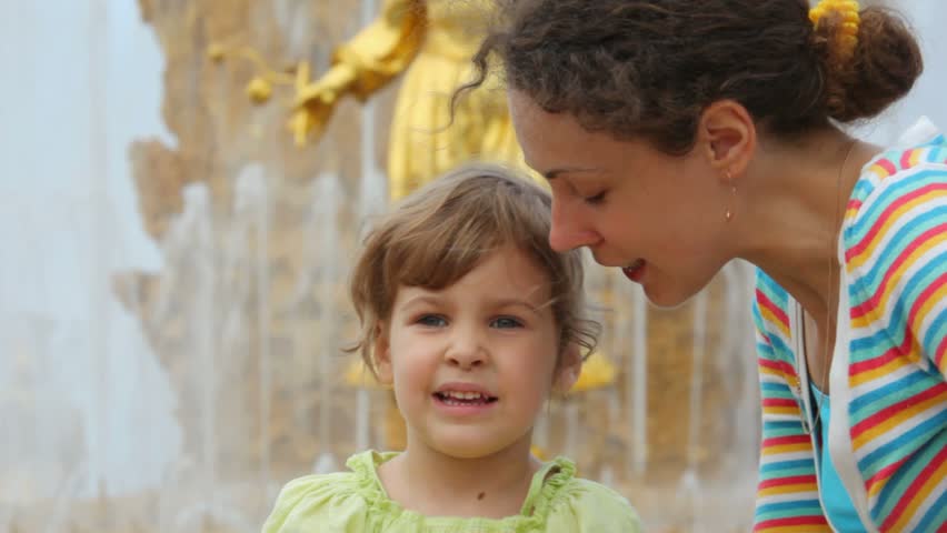 Mother and daughter talk near Fountain Friendship of Peoples 