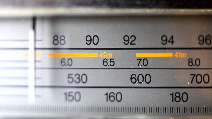 an analogue radio dial tuning in different radio frequencies