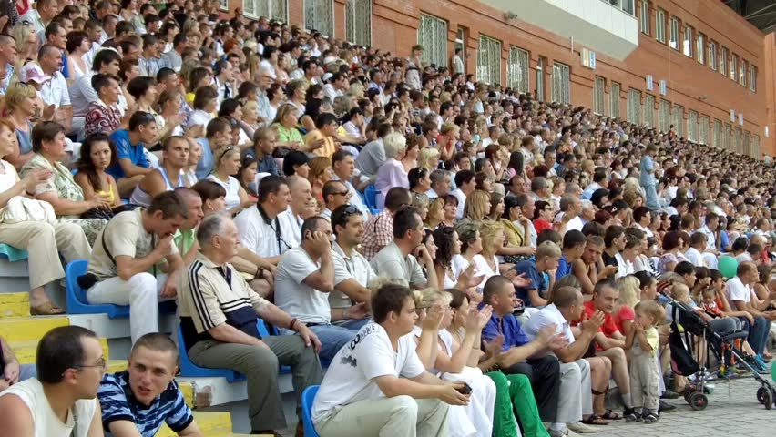 SUMY, UKRAINE - JUNE 28: The audience applauded in the stands at a football match 28, 2010 in Sumy, Ukraine