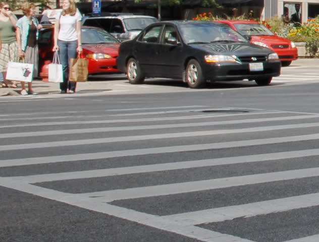 Crowds crossing urban street time lapse