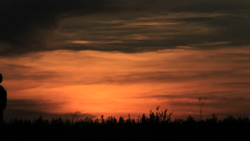 Boys play, a silhouette, sunrise