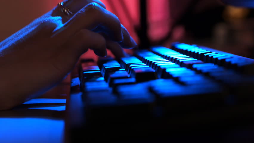 Sequence of macro shots of typing under colored lights