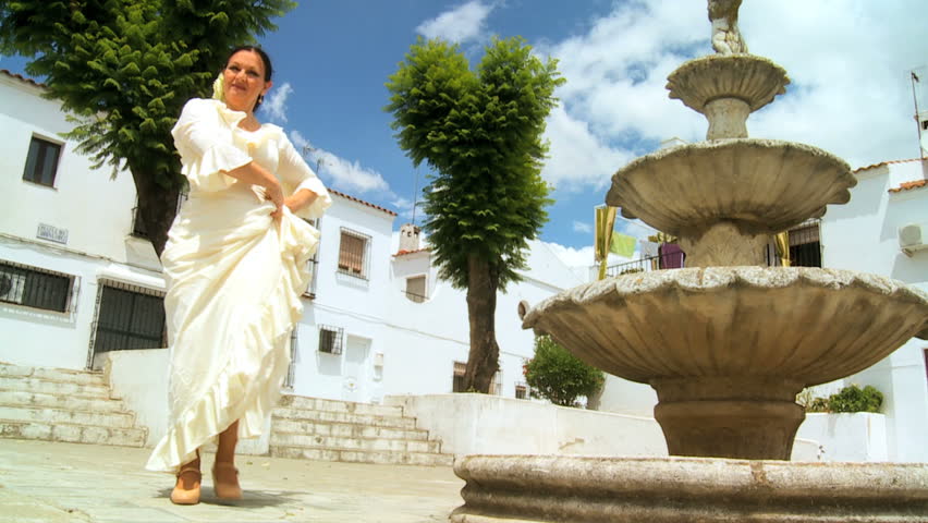 Lady in traditional dress dancing spanish flamenco in town square Seville, Spain, with audio 