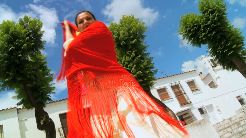 Lady in traditional dress dancing spanish flamenco in town square Seville, Spain  
