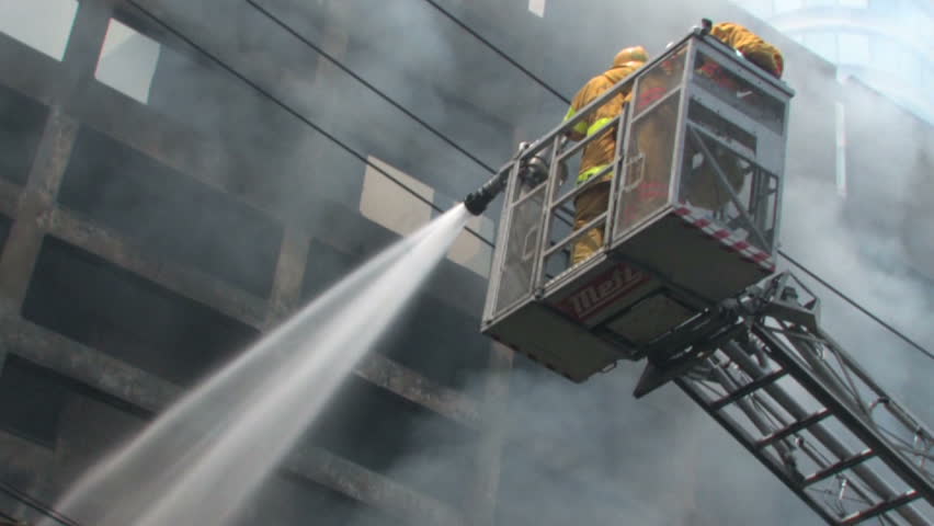 BANGKOK, THAILAND - April 19, 2010: Firemen battle blazes across the city after protesters set more than 40 buildings on fire during a government crackdown 
