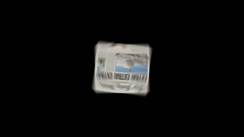1080p HD Video. Color version of a retro spinning newspaper on a black background that zooms from far away to close up.