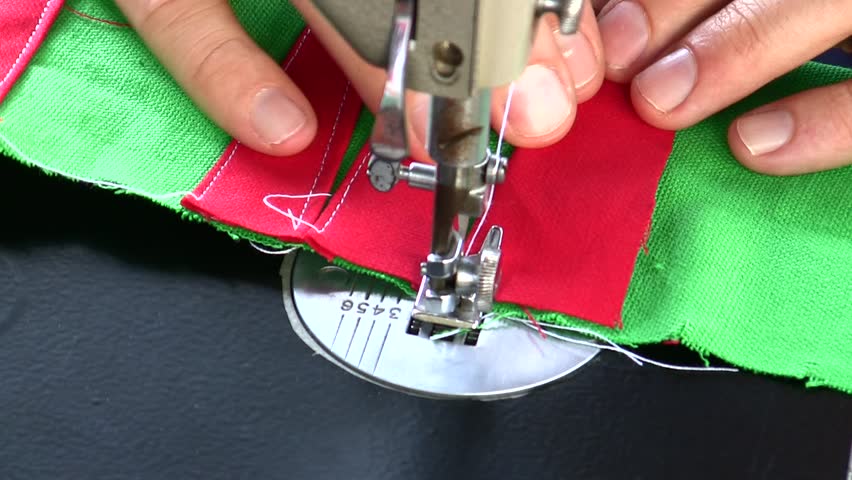 Hands of tailor sewing backgammon game