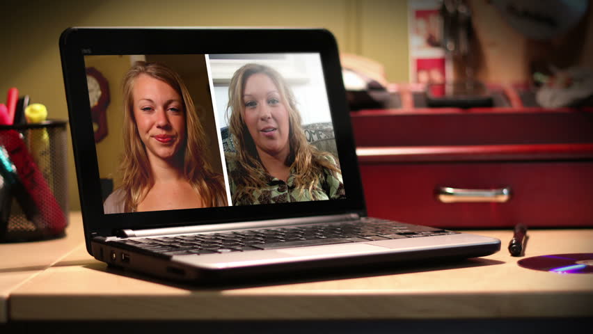 Two women video chat on a portable laptop computer.