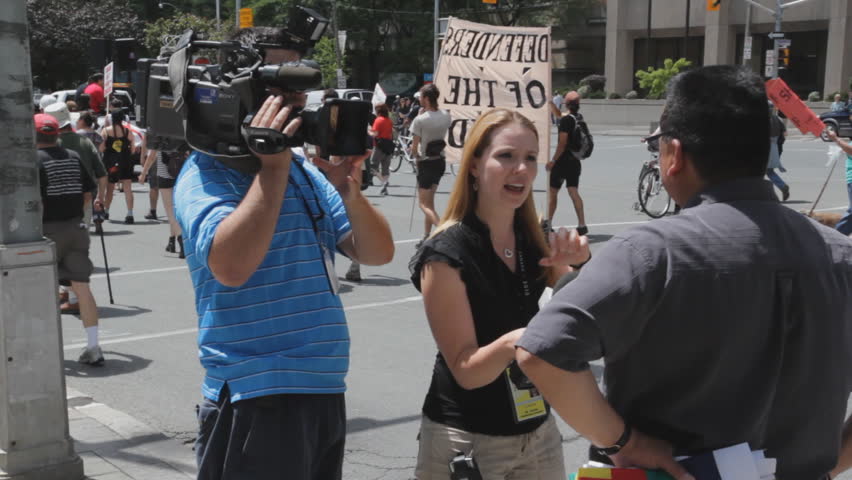 TORONTO, ONTARIO - JUNE 24th: Woman interviews native leader on June 24th, 2010, Toronto, Ontario, Canada. Native groups staged a peaceful  protest on the eve of the G20.  
