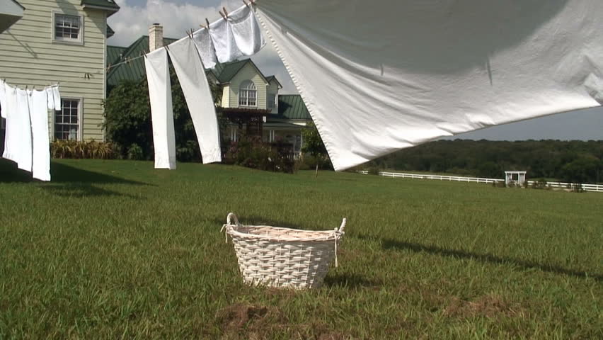 Shot of sheets and towels on a clothesline drying in the sun