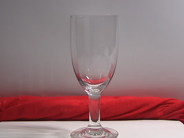 Time lapse of ice melting in a glass and then drinking the cool water through a straw. 