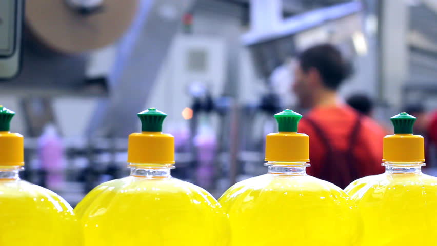 Industrial scene of automated dish-washing detergent production line in modern factory.