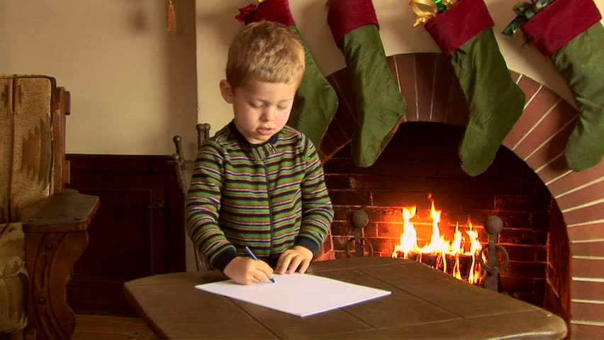 Little boy writing a letter to Santa at Christmas