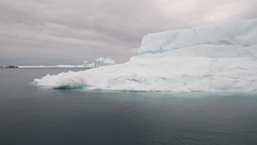 Sailing by an iceberg in the famous Ilulissat icefjord in Greenland. The icefjord is on UNESCO's World Heritage List.