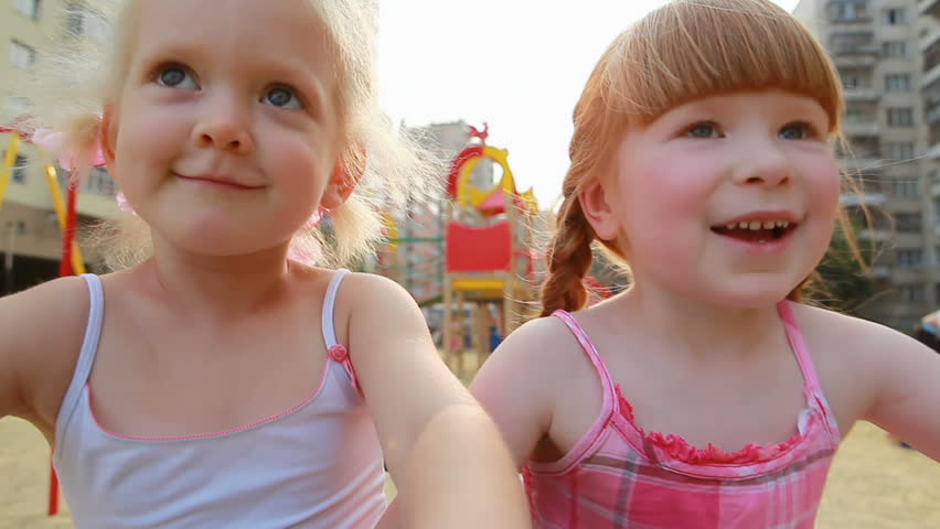 Two little girls on carousel