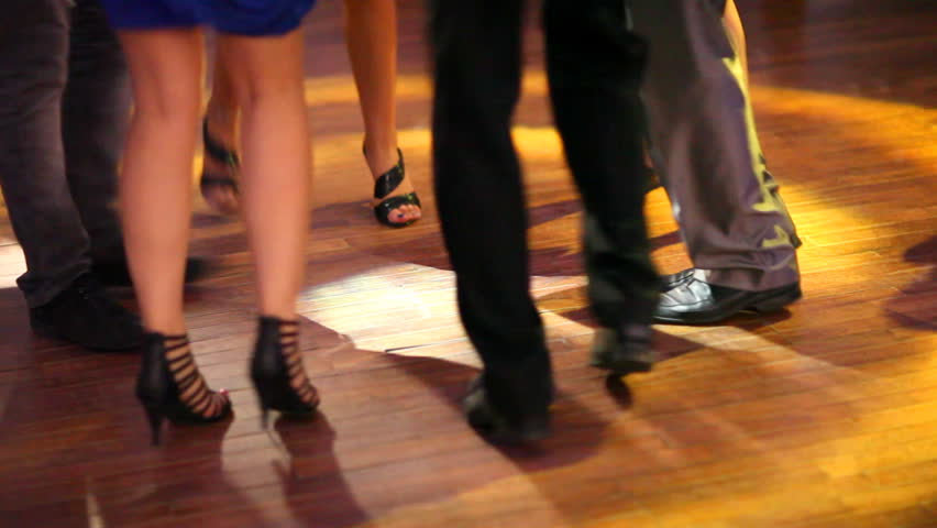 People dancing on disco. Legs closeup view. 