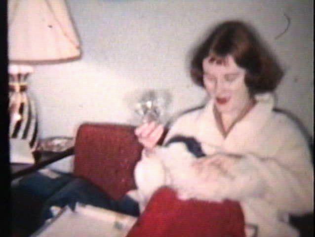 A young couple enjoy opening Christmas presents but the best gift is the Christmas budgie Perky!
