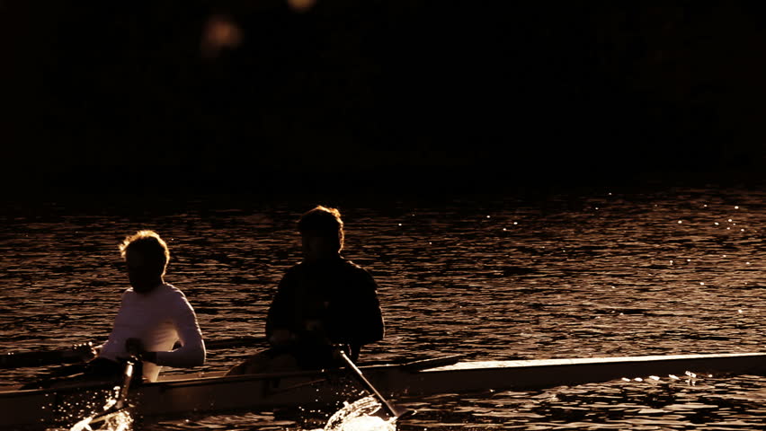 Rowing training on the river in early morning in silhouette