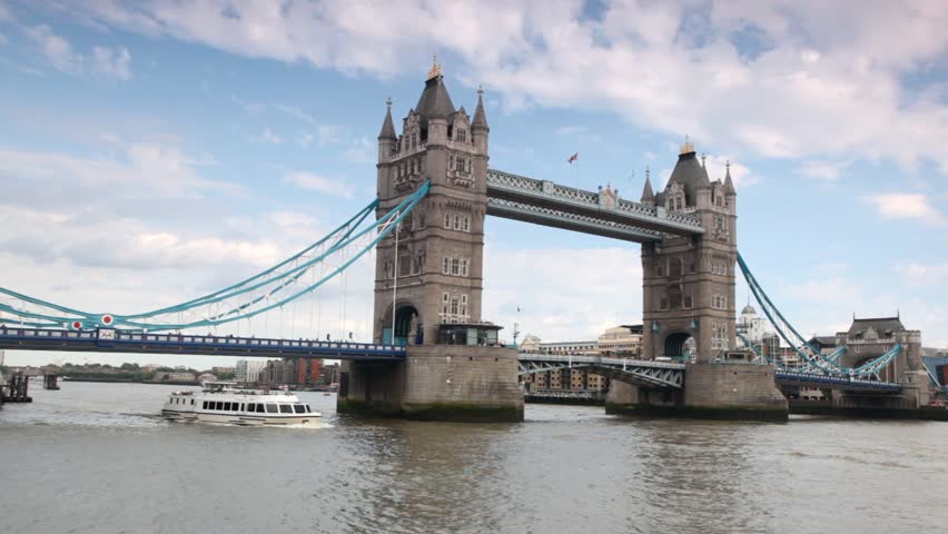 Excursion boat slowly going under magnificent Tower Bridge in London