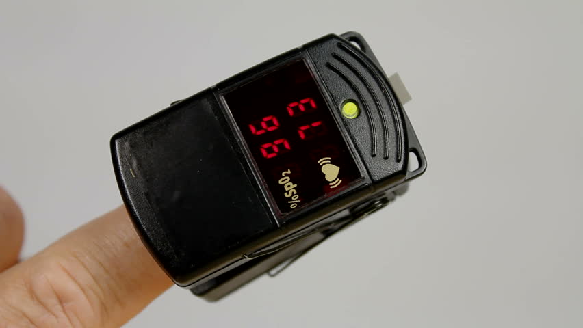 Pulse oximeter, placed on finger during office examination, registers vitals, then nurse removes it. 1080p