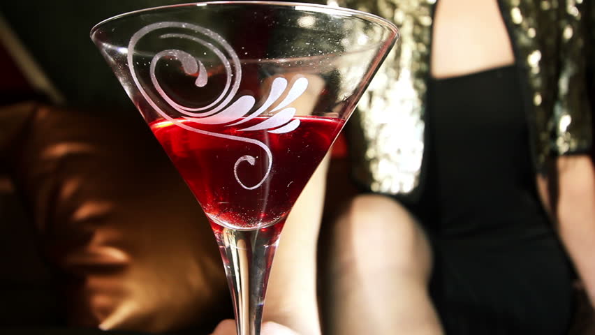 beautiful classic pinup girl in a VIP club drinking a cocktail