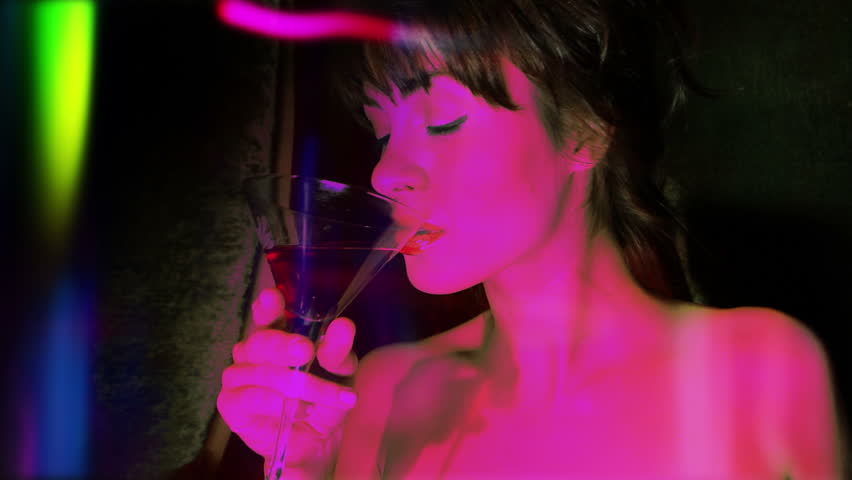 beautiful classic pinup girl in a VIP club drinking a cocktail