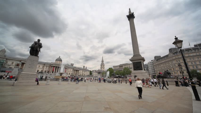 LONDON - JUNE 8: Many tourists walking in Trafalgar Square on a cloudy day, June 8, 2010 in London, England. With its position in the heart of London, it is a tourist attraction, and one of the most famous squares in the United Kingdom and the world.