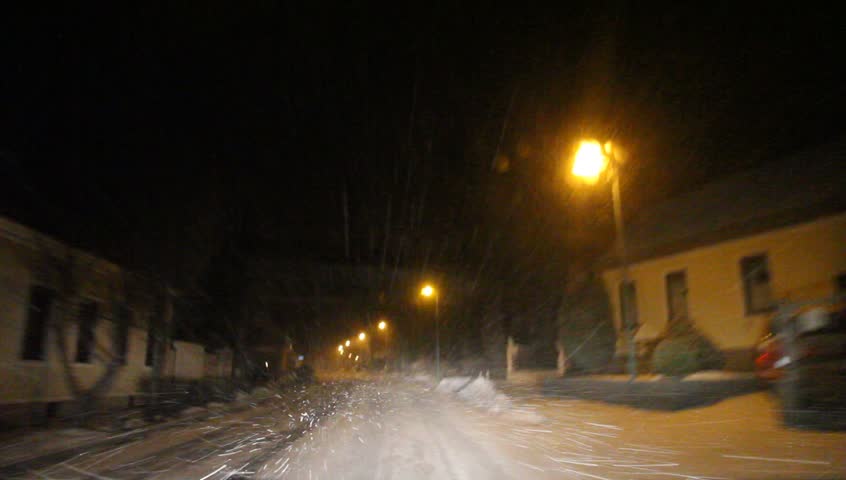 Driving at night through a snow covered village in Lower Austria