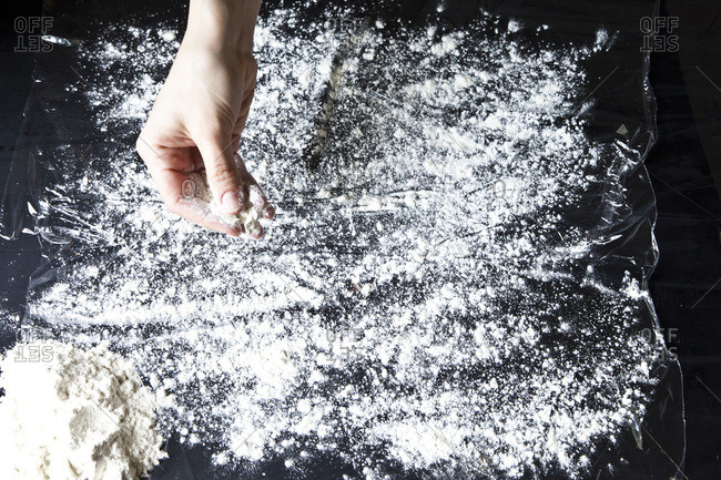 Action shot of hands preparing a pie on a floured surface