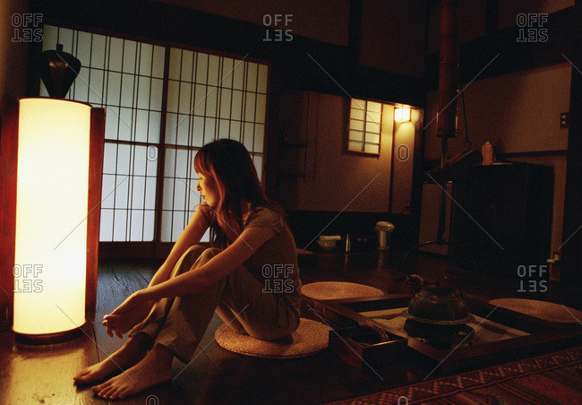 Japan, woman sitting in a hotel room